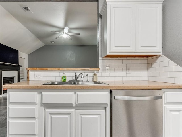 kitchen featuring visible vents, dishwasher, light countertops, white cabinetry, and a sink