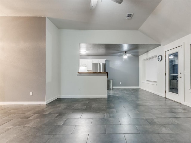 unfurnished living room with ceiling fan, visible vents, and baseboards