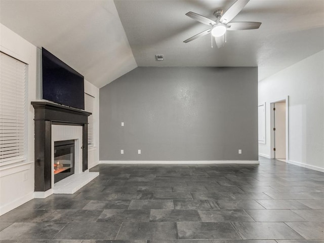 unfurnished living room featuring lofted ceiling, ceiling fan, a fireplace, and baseboards