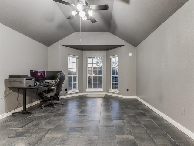 unfurnished office with a ceiling fan, vaulted ceiling, and baseboards