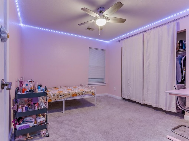 bedroom with visible vents, a ceiling fan, and light colored carpet