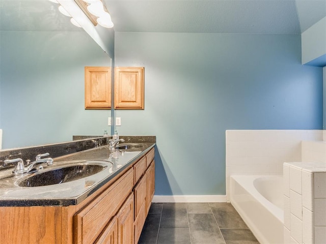 full bathroom featuring a garden tub, double vanity, a sink, and baseboards