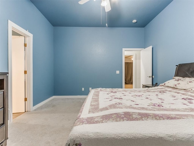 bedroom with baseboards, a ceiling fan, and light colored carpet