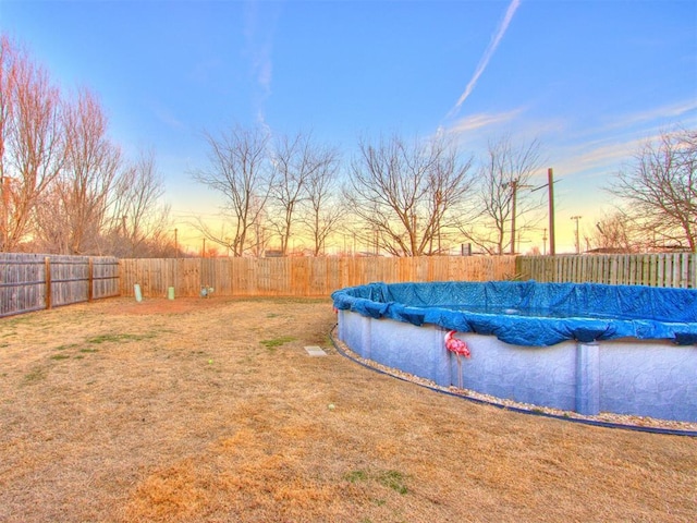 view of pool featuring a fenced backyard, a fenced in pool, and a yard