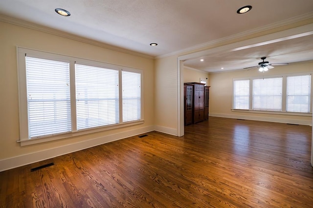 unfurnished living room with visible vents, dark wood-style flooring, and a wealth of natural light