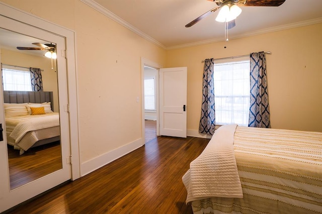 bedroom featuring a ceiling fan, baseboards, dark wood-style flooring, and crown molding