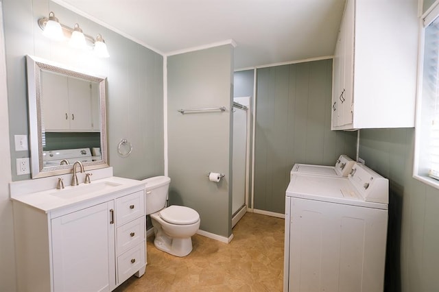 bathroom with toilet, a shower with door, ornamental molding, independent washer and dryer, and vanity