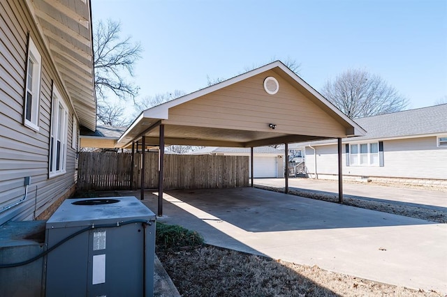 view of vehicle parking featuring fence and driveway