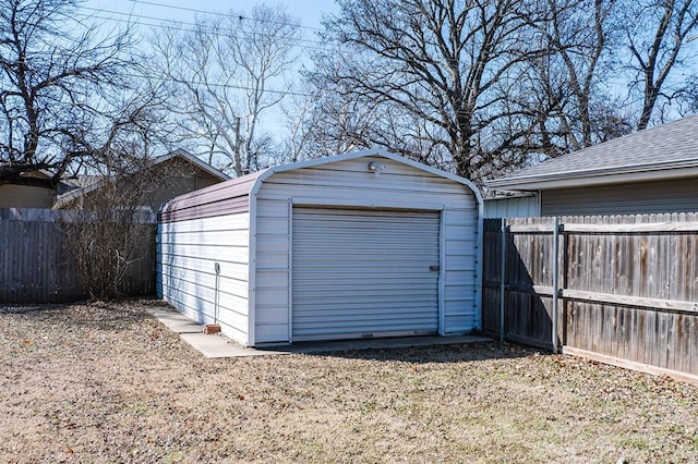 detached garage featuring fence