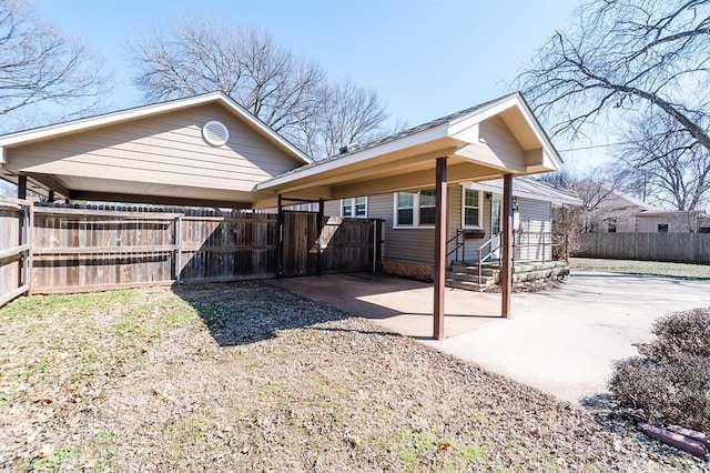 rear view of property featuring fence