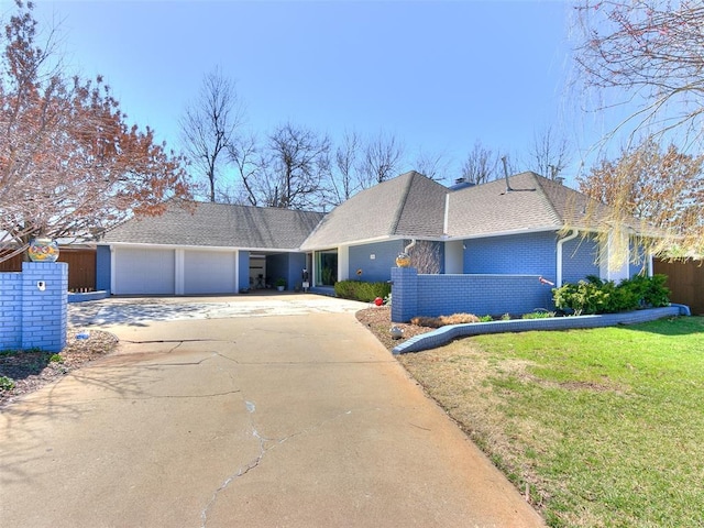 ranch-style home featuring a front lawn, driveway, fence, a garage, and brick siding