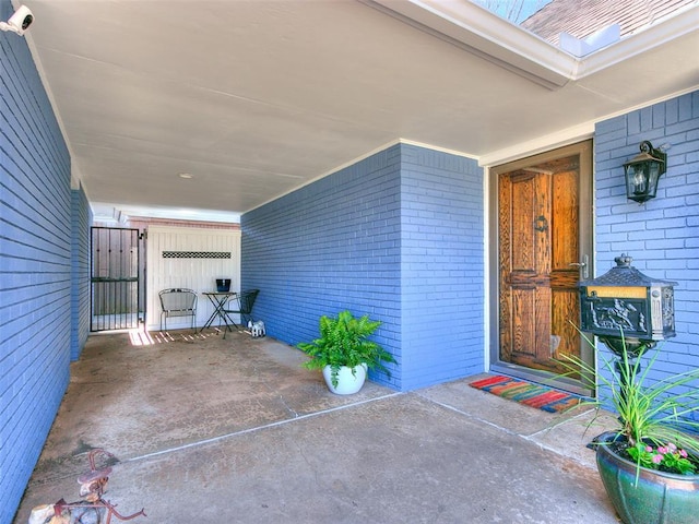 doorway to property with brick siding