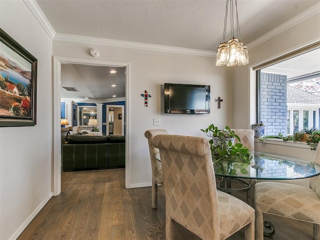 dining room featuring baseboards, dark wood finished floors, and ornamental molding