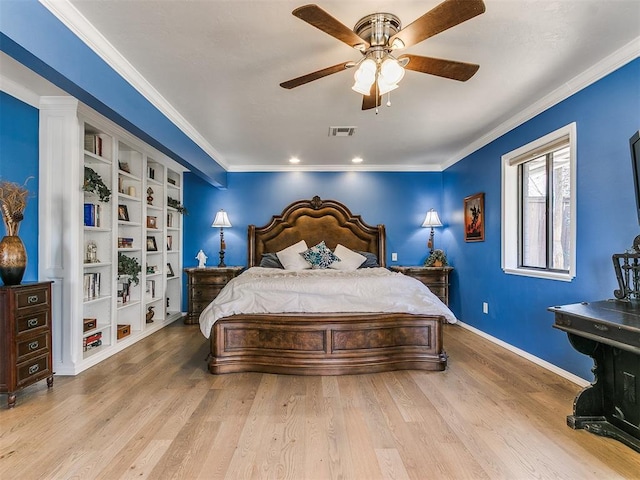 bedroom with baseboards, wood finished floors, visible vents, and ornamental molding