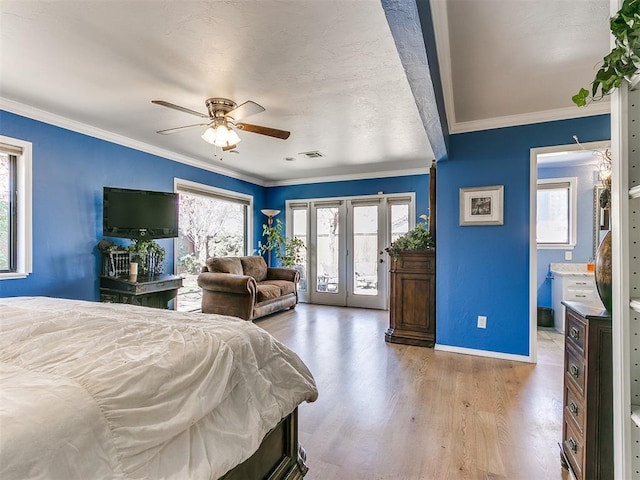 bedroom featuring visible vents, ornamental molding, wood finished floors, baseboards, and access to exterior