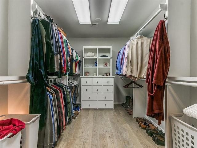 spacious closet featuring visible vents and wood finished floors