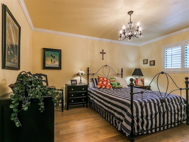 bedroom featuring a notable chandelier, wood finished floors, and crown molding