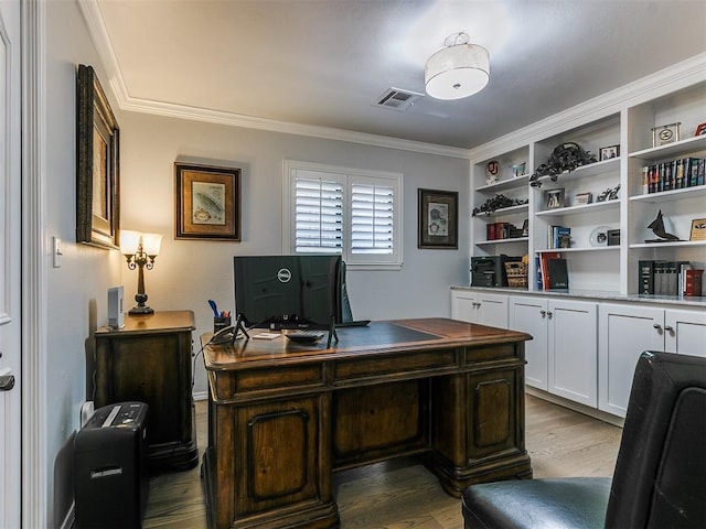 office space with wood finished floors, visible vents, and ornamental molding