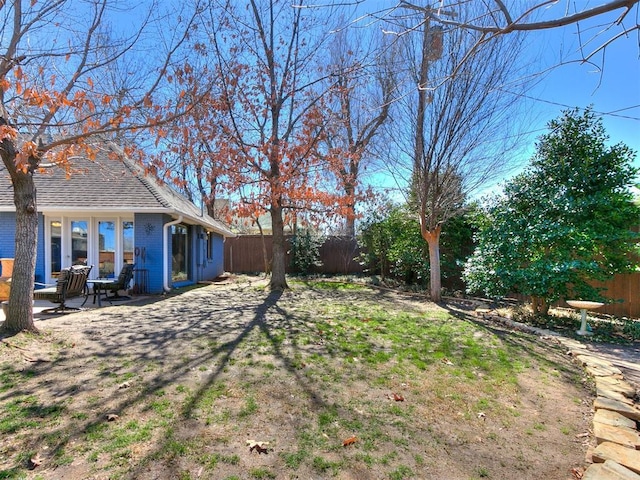 view of yard featuring a patio and fence