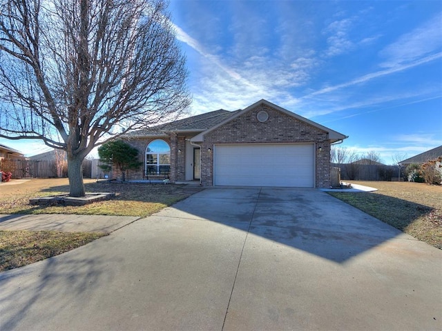 ranch-style home featuring driveway, brick siding, and an attached garage