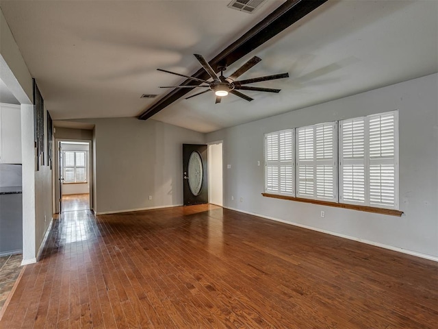 spare room featuring wood-type flooring, visible vents, lofted ceiling with beams, and baseboards