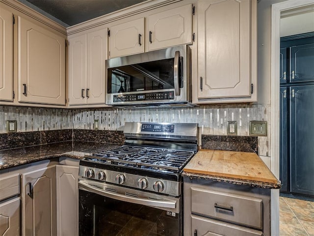 kitchen with light tile patterned floors, tasteful backsplash, and appliances with stainless steel finishes