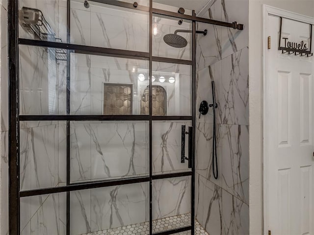 room details featuring a marble finish shower