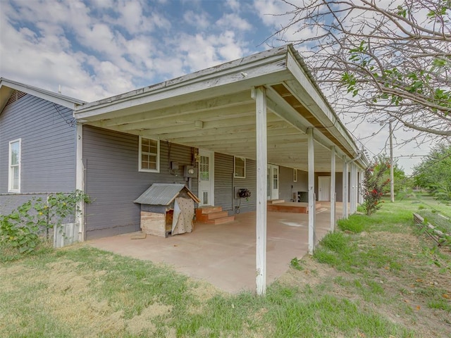 view of patio / terrace with entry steps and a carport