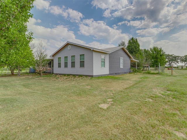 view of property exterior featuring a lawn