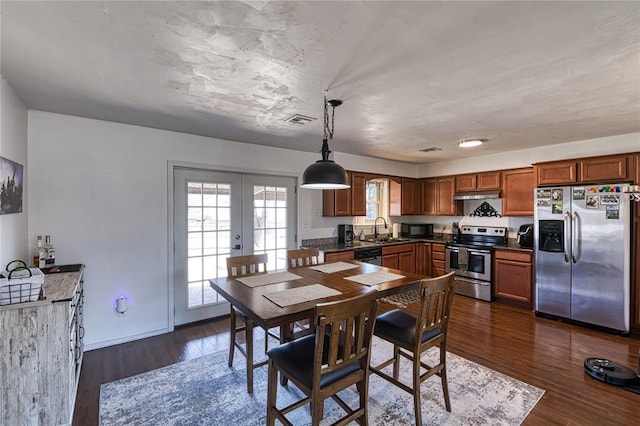 dining area with dark wood-style floors, french doors, visible vents, and baseboards