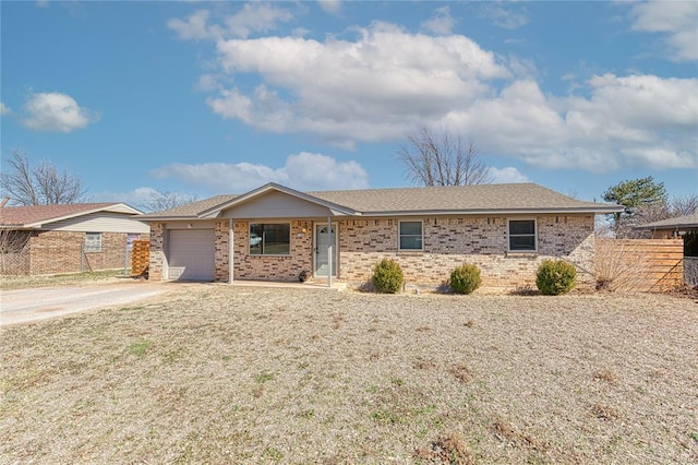 ranch-style house featuring a garage, concrete driveway, brick siding, and fence