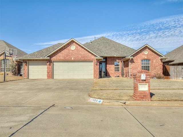 ranch-style home featuring driveway, a shingled roof, an attached garage, and brick siding