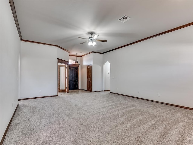 empty room featuring visible vents, arched walkways, baseboards, light colored carpet, and ceiling fan