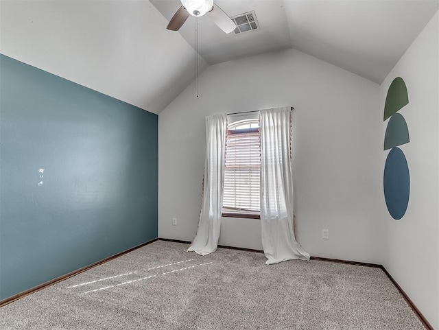 unfurnished room with lofted ceiling, light colored carpet, visible vents, ceiling fan, and baseboards