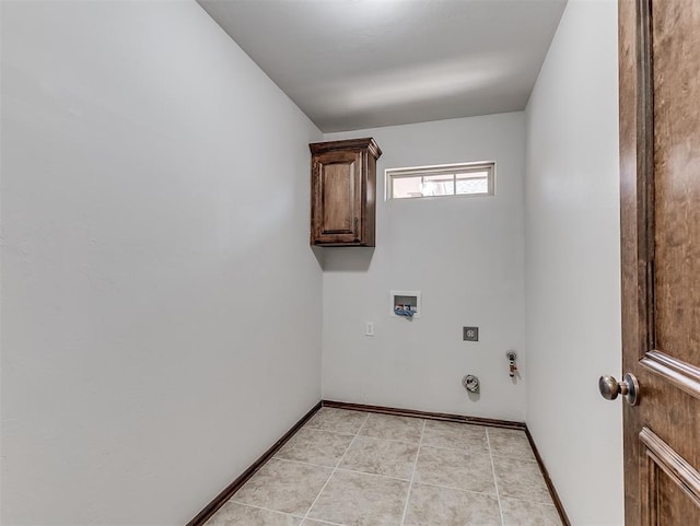 clothes washing area featuring cabinet space, light tile patterned floors, baseboards, hookup for a gas dryer, and washer hookup