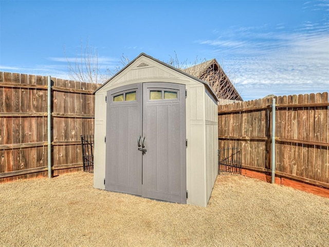 view of shed featuring fence