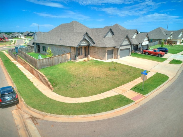 view of front of house with a residential view, driveway, an attached garage, and fence