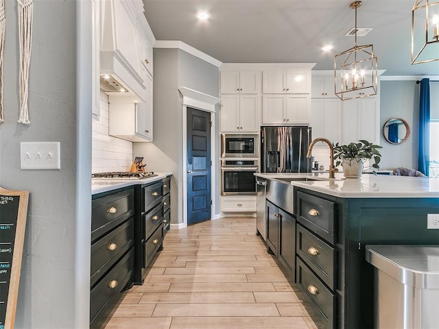 kitchen featuring backsplash, white cabinetry, stainless steel appliances, and light countertops