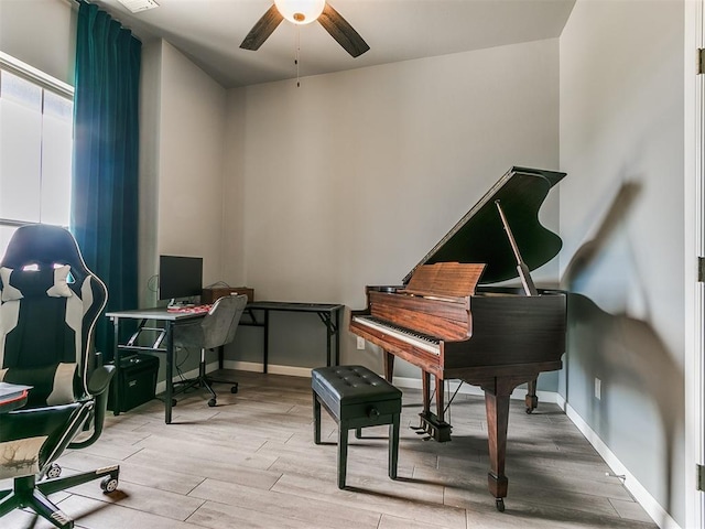 home office with ceiling fan, baseboards, and wood finished floors