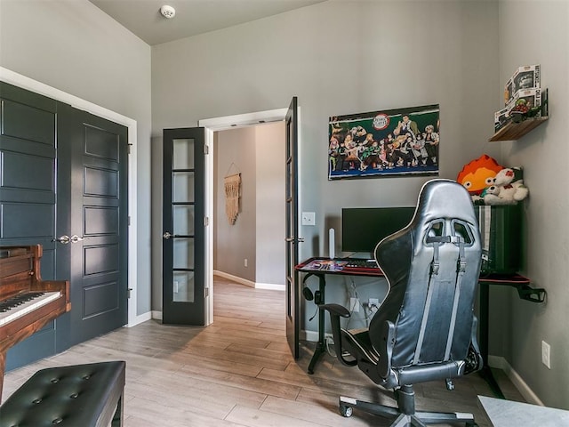 office area with light wood-type flooring and baseboards