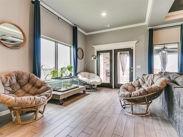 sitting room featuring ornamental molding, wood finished floors, and visible vents