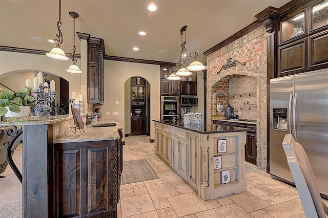 kitchen featuring glass insert cabinets, dark brown cabinetry, dark stone countertops, arched walkways, and stainless steel appliances