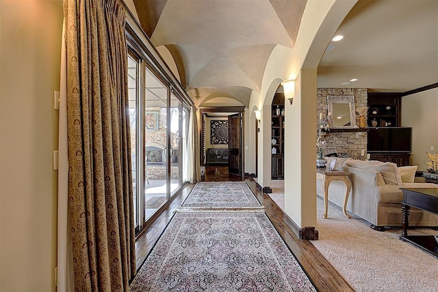 interior space featuring dark wood-type flooring, recessed lighting, and arched walkways