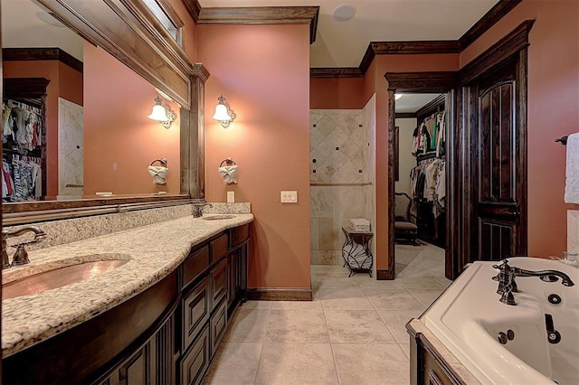 full bath featuring a walk in closet, crown molding, tile patterned floors, and a sink