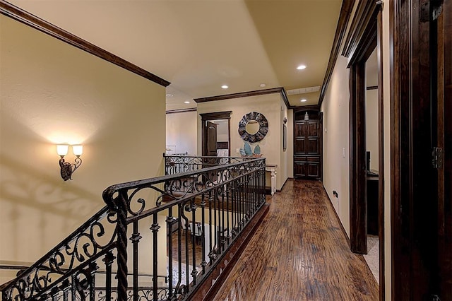 corridor featuring baseboards, ornamental molding, an upstairs landing, recessed lighting, and wood finished floors