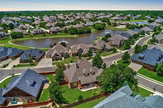 drone / aerial view featuring a residential view and a water view