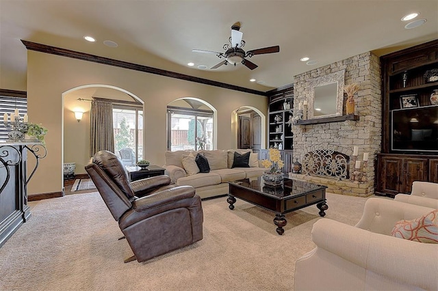 carpeted living room featuring built in shelves, a fireplace, recessed lighting, and ornamental molding