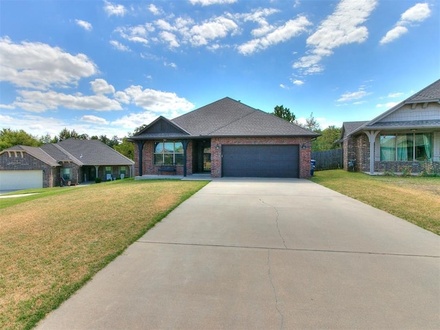 view of front of house with a front yard, brick siding, driveway, and an attached garage