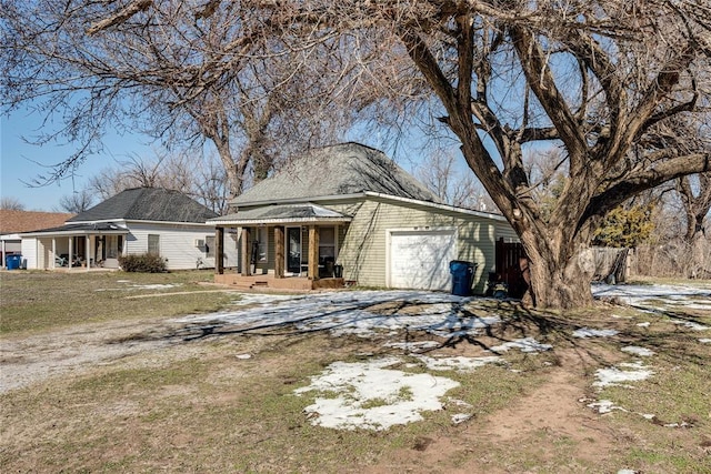 view of front of property featuring a garage, driveway, and a porch