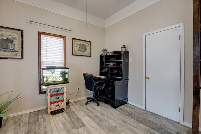 home office featuring light wood finished floors and baseboards